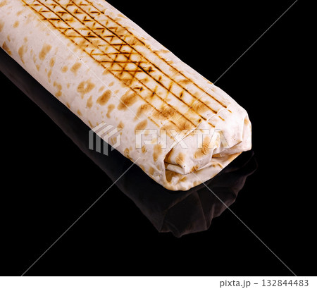 Grilled flatbread wrap with distinct patterns on glossy surface Grilled flatbread wrap with distinct patterns on glossy surface 132844483