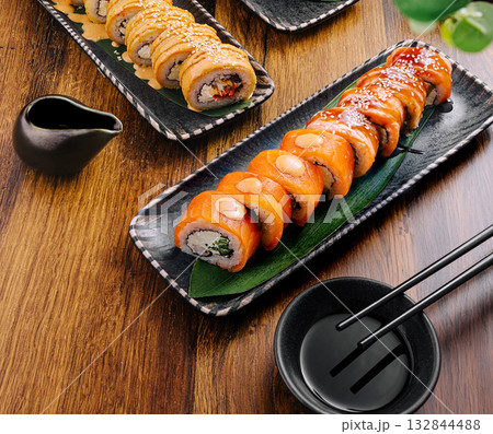 Colorful sushi rolls served on elegant plates at a Japanese restaurant Colorful sushi rolls served on elegant plates at a Japanese restaurant 132844488