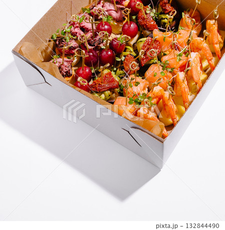 Gourmet appetizer platter featuring shrimp, beef, and vegetables for a party 132844490