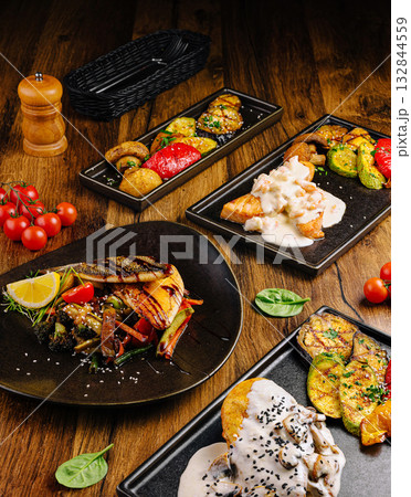 Grilled vegetables and seafood served on black dishes with fresh ingredients Grilled vegetables and seafood served on black dishes with fresh ingredients 132844559