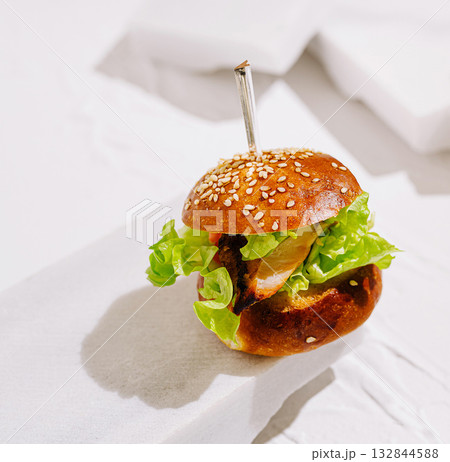 Delicious crispy chicken burger with fresh lettuce on a white background 132844588