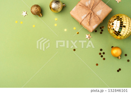 Christmas gift with ornaments on a green background Christmas gift with ornaments on a green background 132846101