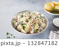 Potato salad with pickled cucumbers and onions on gray background. Copy space. German, American cuisine. 132847182