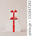 White gift box with a red bow on a white background. Holiday concept, birthday, sale, marketing.  132847262