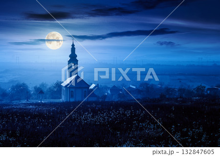old church in the village in autumn at night. view of countryside landscape from a hill in haze and full moon light. empty rural fields. background for investment or abstract concepts old church in the village in autumn at night. view of countryside landscape from a hill in haze and full moon light. empty rural fields. background for investment or abstract concepts 132847605