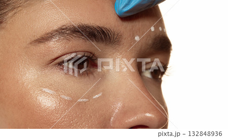 Forehead marking before injection procedure in dermatologic clinic 132848936