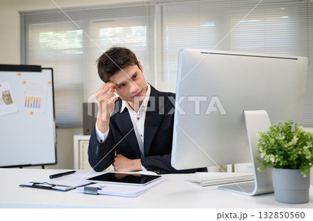 Shot of a businessman looking stressed out while working on a computer 132850560