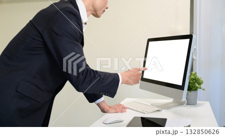 Rear view of businessman working with computer in modern office. Rear view of businessman working with computer in modern office. 132850626