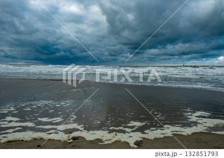 tempest over shoreline and surf, intense weather scenario with turbulent surf and moist beach tempest over shoreline and surf, intense weather scenario with turbulent surf and moist beach 132851793