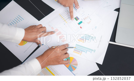 Business team analyzing financial report and marketing data chart for strategy planning Business team analyzing financial report and marketing data chart for strategy planning 132852037
