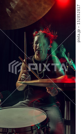 Rock drummer hitting cymbal with emotion and colorful stage motion blur Rock drummer hitting cymbal with emotion and colorful stage motion blur 132852817