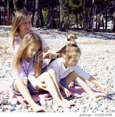 mother with twins daughters on beach mother with twins daughters on beach 132853240