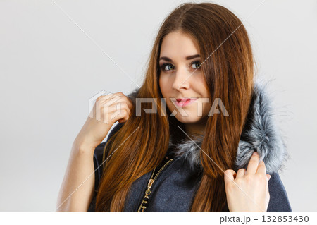 Happy woman wearing dark poncho coat with hood Happy woman wearing dark poncho coat with hood 132853430