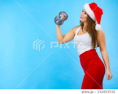 Santa claus woman lifting dumbbells 132853510