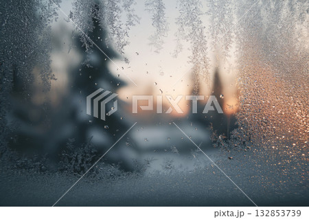 Frosted window with ice crystals and blurred winter trees outside 132853739