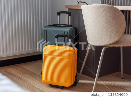 Travel suitcases standing in modern hotel room, waiting for journey 132854009
