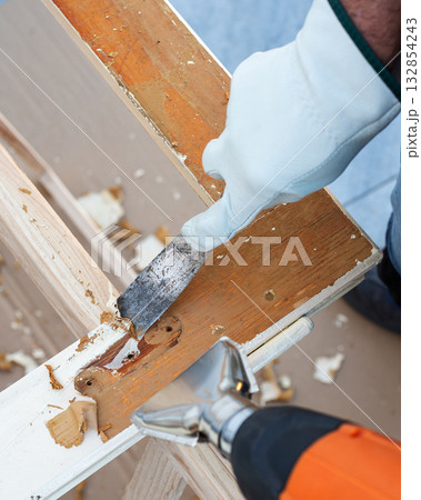 Carpenter at work, restoring an old wooden window. Carpentry. Carpenter at work, restoring an old wooden window. Carpentry. 132854243