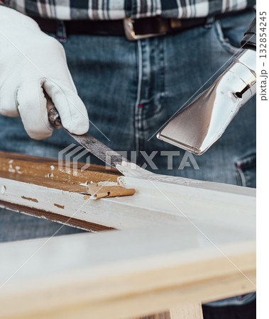 Carpenter at work, restoring an old wooden window. Carpentry. Carpenter at work, restoring an old wooden window. Carpentry. 132854245