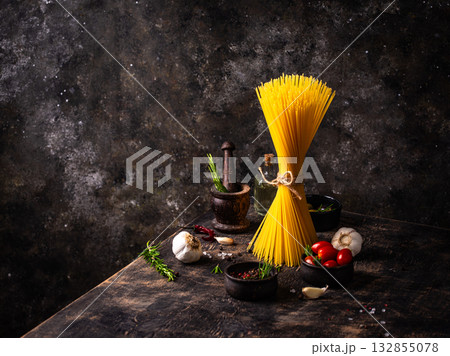 Italian food background with spaghetti, tomato and spices 132855078