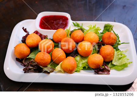 Delicious Beer Snack Platter with Fried Squid Rings, Cheese Sticks, Cheese Balls, Onion Rings, and Garlic Croutons. Delicious Beer Snack Platter with Fried Squid Rings, Cheese Sticks, Cheese Balls, Onion Rings, and Garlic Croutons. 132855206
