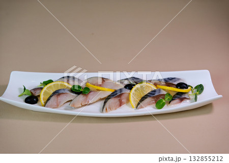 Fresh Mackerel Sashimi Served on Ice with Lemon and Garnishes 132855212