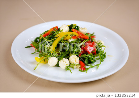 mozzarella cheese balls bowl of colorful salad in a white ceramic bowl top down view isolated 132855214