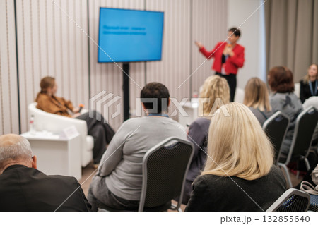 Business seminar where a speaker presents to an attentive audience in a conference room setting. Business seminar where a speaker presents to an attentive audience in a conference room setting. 132855640