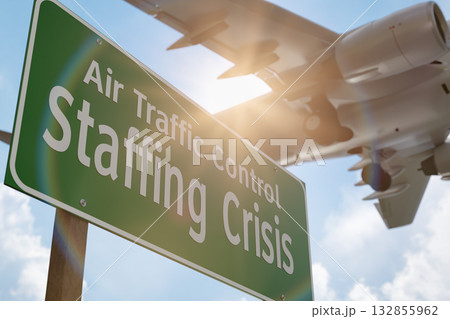 Air Traffic Control Staffing Crisis Green Road Sign with Airplane Above. Air Traffic Control Staffing Crisis Green Road Sign with Airplane Above. 132855962