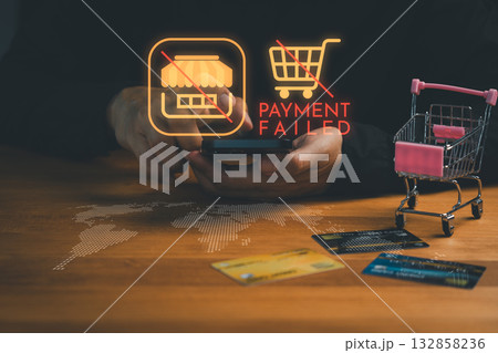 Online shopping payment failed concept with credit cards, smartphone, and hologram alert icon, symbolizing declined transaction, e-commerce error, financial problem and digital purchase failure. 132858236