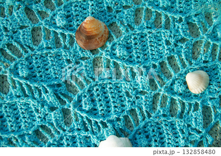 Hand-knitted blue cotton scarf with seascape of fish and shells on it Hand-knitted blue cotton scarf with seascape of fish and shells on it 132858480