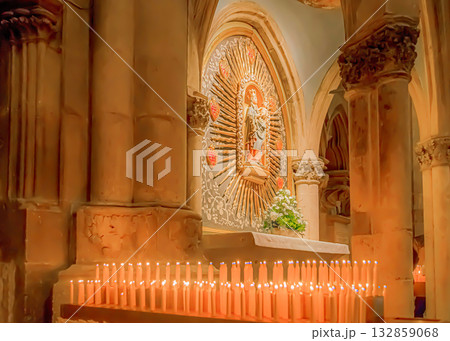 Serene church interior with lit candles 132859068