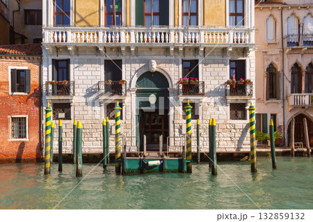 Canal Facade with Mooring Poles in Venice, Italy Canal Facade with Mooring Poles in Venice, Italy 132859132