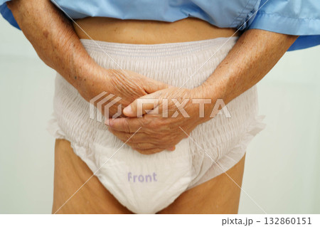 Asian senior woman patient wearing adult incontinence diaper pad in hospital. 132860151