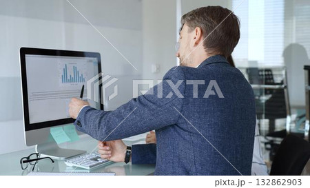 Business professionals analyzing financial data, discussing market trends, and collaborating on a project in the office. Businesspeople concept 132862903