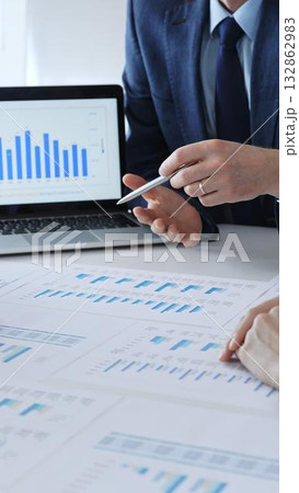Business people having a financial meeting, discussing company strategy, reviewing data analysis, and planning future growth using charts and reports 132862983