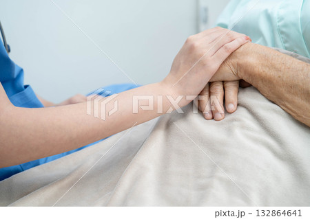 Asian doctor checking and treat elderly woman patient health in hospital. Asian doctor checking and treat elderly woman patient health in hospital. 132864641