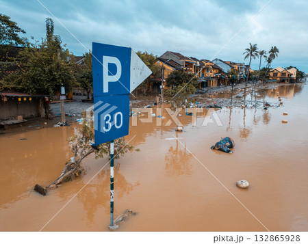 flooded city or town with buildings submerged in overflow water and mud, village underwater after heavy tropical rain and typhoon, consequences with dirt on the street flooded city or town with buildings submerged in overflow water and mud, village underwater after heavy tropical rain and typhoon, consequences with dirt on the street 132865928