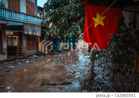 flooded city or town with buildings submerged in overflow water and mud, village underwater after heavy tropical rain and typhoon, consequences with dirt on the street 132865931