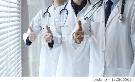 Medical team showing thumbs up gestures, symbolizing healthcare success, collaboration, good results, excellent medical service, and professional doctor approval Medical team showing thumbs up gestures, symbolizing healthcare success, collaboration, good results, excellent medical service, and professional doctor approval 132866569