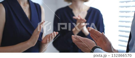 Business people clapping hands, showing support and appreciation for achievements, success, and accomplishment during a company meeting or presentation in modern office Business people clapping hands, showing support and appreciation for achievements, success, and accomplishment during a company meeting or presentation in modern office 132866570
