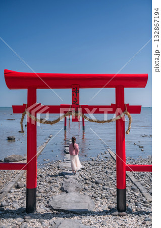 Japanese girl at red torii gate of Oouo Shrine by Ariake sea, Saga Japanese girl at red torii gate of Oouo Shrine by Ariake sea, Saga 132867194