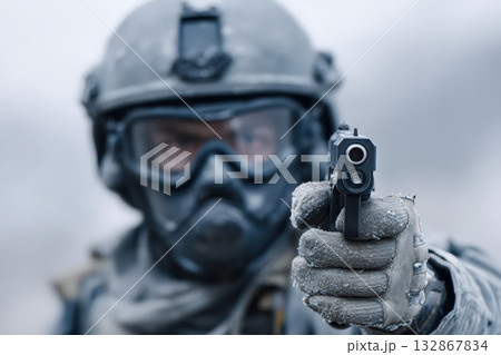 Soldier in tactical gear aims sidearm during winter training exercise in a remote location Soldier in tactical gear aims sidearm during winter training exercise in a remote location 132867834