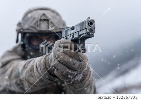 Soldier in winter gear aiming a pistol during training in a snowy landscape 132867835