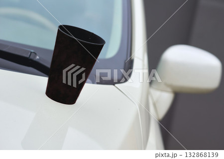 Tea time coffee break. Paper cup of coffee, tea on the hood of the car 132868139