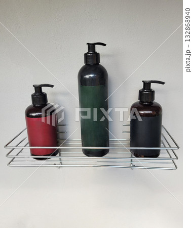Bottles with Dispensers on Wire Shelf 132868940