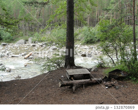A turbulent stream of clear water from the high mountains continues its movement over the rocks  132870869