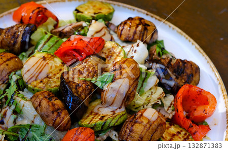 grilled vegetables eggplant, pepper, onion, tomato and beans on black background. grilled vegetables eggplant, pepper, onion, tomato and beans on black background. 132871383