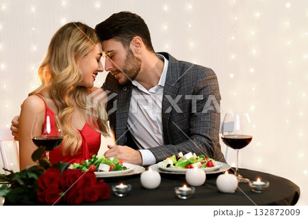 Romantic Evening. Loving Young Couple Bonding On Date In Restaurant, Touching Foreheads, Enjoying Time Together Romantic Evening. Loving Young Couple Bonding On Date In Restaurant, Touching Foreheads, Enjoying Time Together 132872009