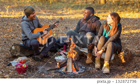 International group of people camping and singing in autumn forest, copy space International group of people camping and singing in autumn forest, copy space 132872736