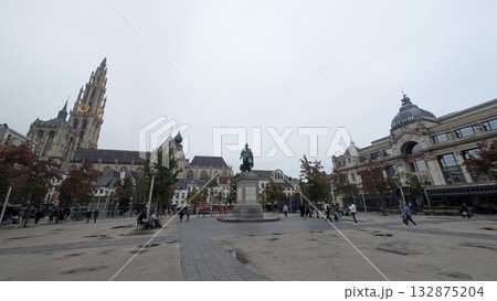 A sculpture and a cathedral view at the square in Antwerp 132875204